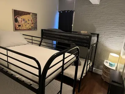 a bedroom with a bunk bed and a piano at New York Skyline One of a Kind View in Union City