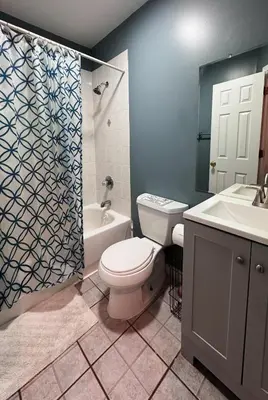 a bathroom with a toilet and a sink and a shower at New York Skyline One of a Kind View in Union City
