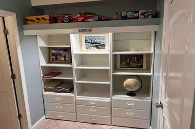 a walk in closet with white drawers and shelves at NY-NJ Tennis Suites - Sleeps 40 - 15 Mins to NYC in Union City