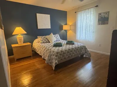 a bedroom with a bed and a lamp and a window at NY-NJ Tennis Suites - Sleeps 40 - 15 Mins to NYC in Union City