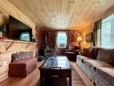 a living room with a couch and a table at Fern Hollow Home