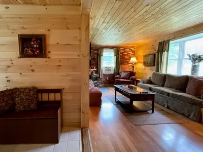 a living room with a couch and a table at Fern Hollow Home