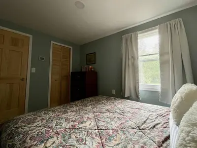 a bedroom with a bed and a window at Fern Hollow Home