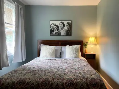 a bedroom with a bed with two people on it at Fern Hollow Home