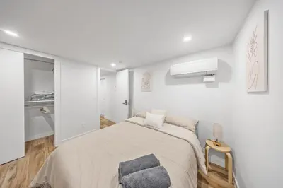a white bedroom with a bed and a window at Double Room at a shared Apartment near Times Square in New York