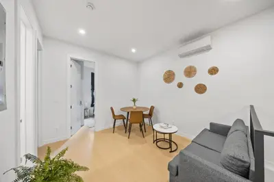 a living room with a couch and a table at Double Room at a shared Apartment near Times Square in New York