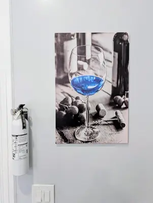 a wine glass with blue liquid sitting on a table at Newly Renovated 2B 2BA apt! mins to PATH & NY! in Jersey City