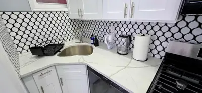 a kitchen with a sink and a counter top at Newly Renovated 2B 2BA apt! mins to PATH & NY! in Jersey City