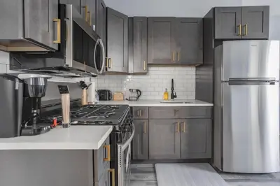 a kitchen with wooden cabinets and a stainless steel refrigerator at Two BR near Metlife with Laundry & Parking in Lodi