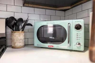 a microwave sitting on a counter in a kitchen at Three BR near Metlife with Laundry & Parking in Lodi