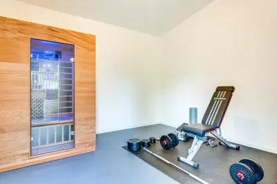 a room with a gym with a treadmill and a window at Private Yard, Playset Family Home in Penn Estates in East Stroudsburg