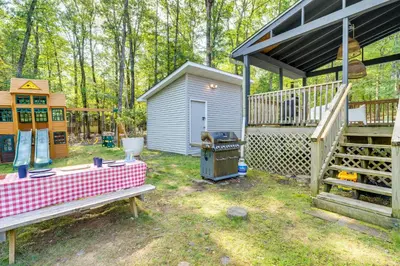 a backyard with a shed and a grill and a house at Private Yard, Playset Family Home in Penn Estates in East Stroudsburg