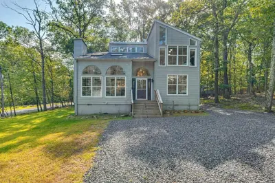a blue house with a porch and a driveway at Private Yard, Playset Family Home in Penn Estates in East Stroudsburg