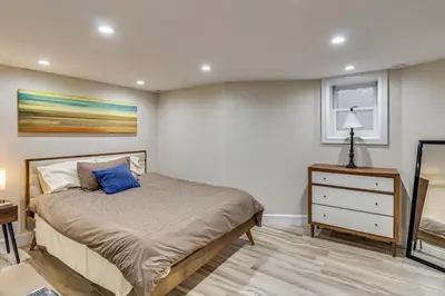 a bedroom with a bed and a dresser at Walk to Hudson River Parks Recently Renovated Apt in Hoboken