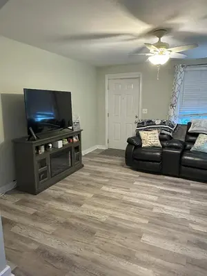 a living room with a couch and a flat screen tv at Cozy 1 BR Retreat within walking distance to all the Hershey Attractions in Hershey