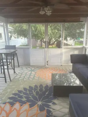 a living room with a door and a rug at Cozy 1 BR Retreat within walking distance to all the Hershey Attractions in Hershey