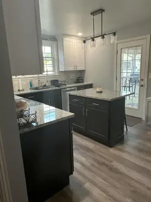 a kitchen with black cabinets and a counter top at Cozy 1 BR Retreat within walking distance to all the Hershey Attractions in Hershey