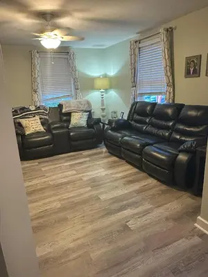 a living room with a black leather couch at Cozy 1 BR Retreat within walking distance to all the Hershey Attractions in Hershey