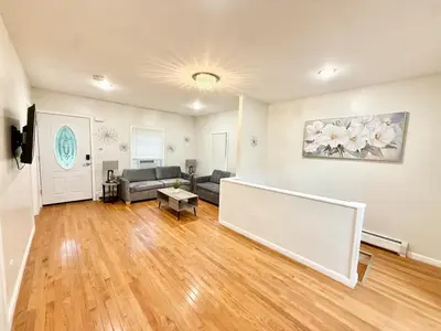 a living room with a couch and a table at Charming Milford Montague Riverway Cottage in Montague