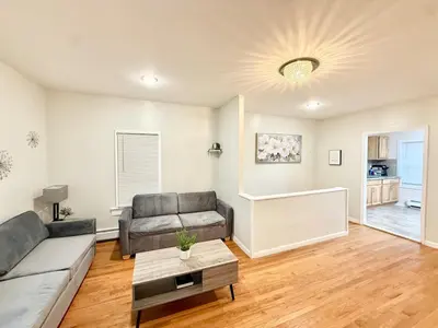 a living room with a couch and a table at Charming Milford Montague Riverway Cottage in Montague