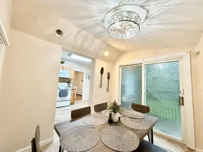 a dining room with a table and chairs and a window at Charming Milford Montague Riverway Cottage in Montague