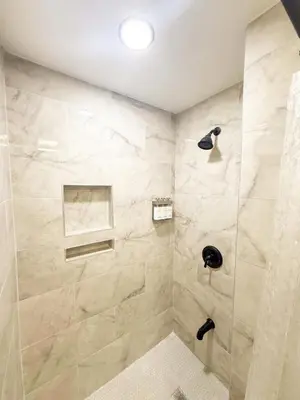 a bathroom with a shower with a glass door at Town & Country Andover, NJ Area- Studio Unit in Newton