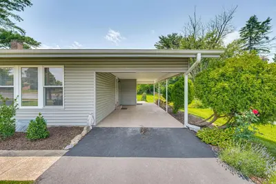 a house with a garage with a driveway at Near Dtwn Harrisburg Stylish Home with Patio and Yard in Camp Hill