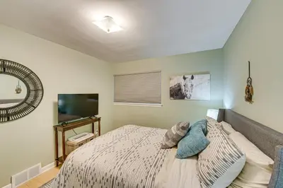 a bedroom with a bed and a flat screen tv at Near Dtwn Harrisburg Stylish Home with Patio and Yard in Camp Hill