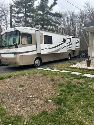 an rv parked in a yard next to a house at Art Rv motorhome in Quakertown