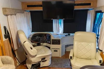 a view of a vehicle with two chairs and a tv at Art Rv motorhome in Quakertown