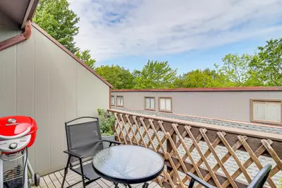 a balcony with a table and chairs and a grill at Modern Mountain Escape in Poconos Walk to Slopes! in Tannersville