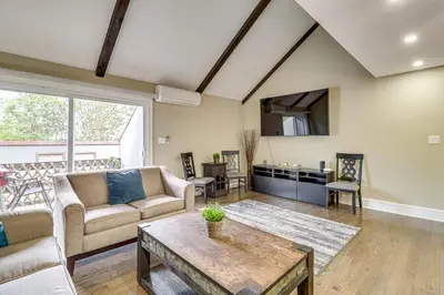 a living room with a couch and a table at Modern Mountain Escape in Poconos Walk to Slopes! in Tannersville