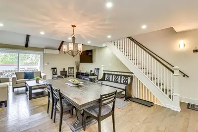 a dining room and living room with a table and chairs at Modern Mountain Escape in Poconos Walk to Slopes! in Tannersville