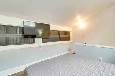 a bedroom with a bed and a flat screen tv at Modern Mountain Escape in Poconos Walk to Slopes! in Tannersville
