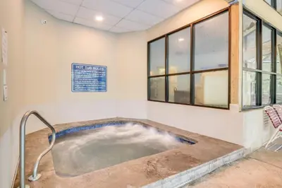 a hot tub in a room with windows at Modern Mountain Escape in Poconos Walk to Slopes! in Tannersville