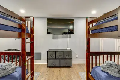 a bedroom with two bunk beds and a desk at Modern Mountain Escape in Poconos Walk to Slopes! in Tannersville