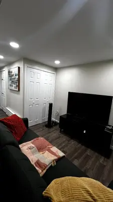 a living room with a couch and a flat screen tv at Cozy Garden 1Bed Apt, Lincoln Park in Jersey City