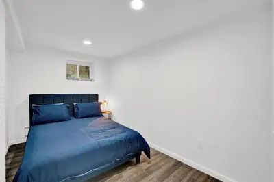 a bedroom with a bed in a white room at Cozy Garden 1Bed Apt, Lincoln Park in Jersey City