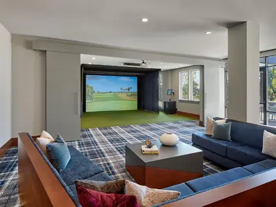 a living room with a couch and a large screen at AVE Blue Bell - Short Stay Furnished Apartment in Blue Bell