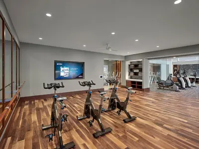 a gym with treadmills and exercise bikes in a room at AVE Blue Bell - Short Stay Furnished Apartment in Blue Bell