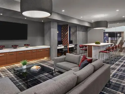 a living room with a couch and a kitchen at AVE Blue Bell - Short Stay Furnished Apartment in Blue Bell