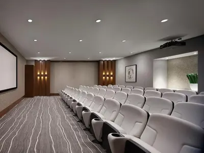 a conference room with white chairs and a screen at AVE Blue Bell - Short Stay Furnished Apartment in Blue Bell