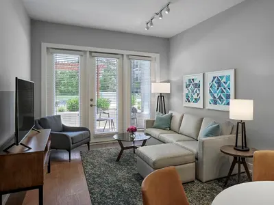 a living room with a couch and a tv at AVE Blue Bell - Short Stay Furnished Apartment in Blue Bell