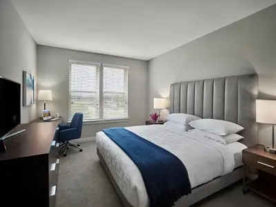a large bedroom with a large bed and a desk at AVE King of Prussia - Short Stay Furnished Apartment in King of Prussia