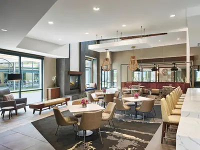 a restaurant with tables and chairs and windows at AVE King of Prussia - Short Stay Furnished Apartment in King of Prussia