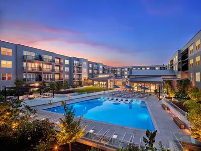 an exterior view of a hotel with a large swimming pool at AVE King of Prussia - Short Stay Furnished Apartment in King of Prussia