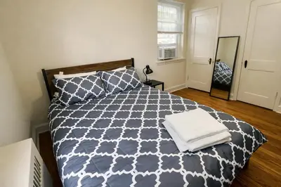 a bedroom with a bed with a blue and white comforter at 1BR Near Philly Free Parking, Monthly Discount in Philadelphia