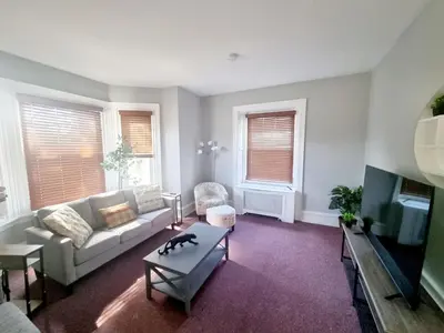 a living room with a couch and a table at Cozy & Inviting A Place to Call Home in Melrose Park