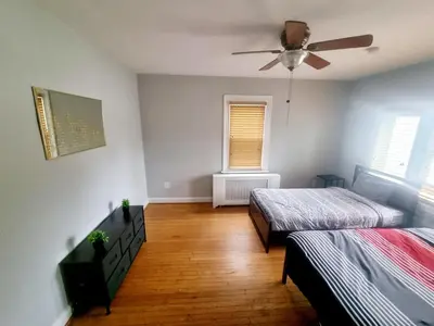 a bedroom with two beds and a ceiling fan at Cozy & Inviting A Place to Call Home in Melrose Park