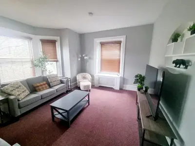 a living room with a couch and a table at Cozy & Inviting A Place to Call Home in Melrose Park